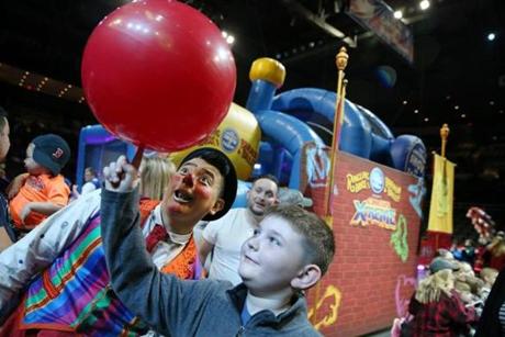 Clown Ivan Vargas showed Nathan Harrington, of Duxbury, how to spin a ball before Saturday?s performance in Providence.
