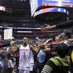 Washington Wizards' Bradley Beal (3) greets fans after Game 4 of a second-round NBA basketball playoff series against the Boston Celtics, Sunday, May 7, 2017, in Washington. (AP Photo/Nick Wass)