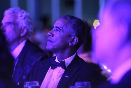 Former US President Barack Obama listened to James Taylor before receiving the annual John F. Kennedy Profile in Courage Award at the the John F. Kennedy Presidential Library and Museum on Sunday. 
