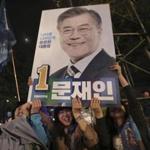 Supporters of South Korea's presidential candidate Moon Jae-in of the Democratic Party hold up his election poster in Seoul, South Korea, Tuesday, May 9, 2017. Exit polls forecast that liberal candidate Moon will win the election Tuesday to succeed ousted President Park Geun-hye. Official results weren't expected for hours, but the exit poll of about 89,000 voters at 330 polling stations, jointly commissioned by three major television stations and released just after polls closed, showed Moon receiving 41.4 percent of the vote. The sign read 