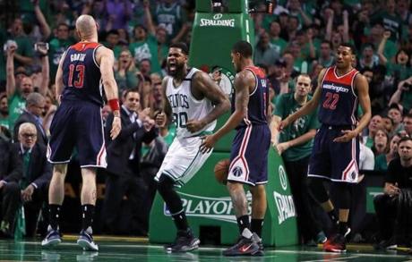 Boston, MA May 10, 2017: The Celtics Amir Johnson brings the crowd out of their seats after he slammed home a feed from Avery Bradley to put Boston ahead 75-57 in the third quarter. The Boston Celtics hosted the Washington Wizards in Game Five of their NBA Eastern Conference semi final playoff series at the TD Garden. (Globe Staff Photo/Jim Davis) 
