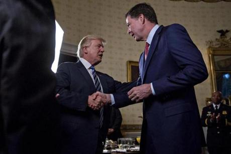 President Donald Trump shakes hands with James Comey, director of the FBI, in January.
