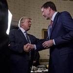 President Donald Trump shakes hands with James Comey, director of the FBI, in January.