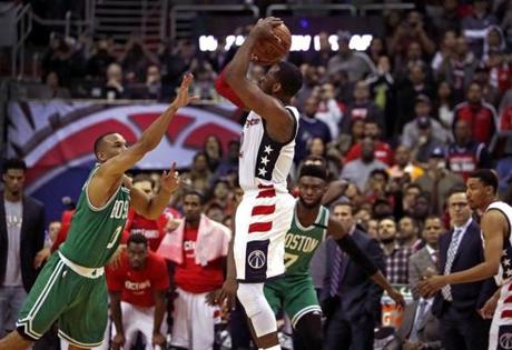 Washington, D.C. - 5/12/2017 - (4th quarter) Washington Wizards guard John Wall (2) shoots the game winning three pointer over Boston Celtics guard Avery Bradley (0) that gave the Wizards a 92-91 lead with 0:03 seconds left in the game. The Washington Wizards host the Boston Celtics in Game 6 of the Eastern Conference Semi-Finals at the Verizon Center in Washington, D.C. - (Barry Chin/Globe Staff), Section: Sports, Reporter: Adam Himmelsbach, Topic: 13Celtics-Wizards, LOID: 8.3.2455943579.
