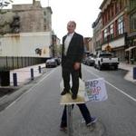 Bill Trommer, of Leeds, Maine, carried a poster of Representative Bruce Poliquin at the end of a protest held outside of his office.  