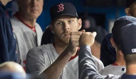Boston Red Sox starting pitcher Chris Sale is congratulated in dugout during the eighth inning of a baseball game against the Toronto Blue Jays in Toronto on Thursday April 20, 2017. (Fred Thornhill/The Canadian Press via AP)
