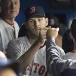 Boston Red Sox starting pitcher Chris Sale is congratulated in dugout during the eighth inning of a baseball game against the Toronto Blue Jays in Toronto on Thursday April 20, 2017. (Fred Thornhill/The Canadian Press via AP)
