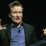 FILE - In this Feb. 12, 2016 file photo television host Conan O'Brien gestures to the audience at Sanders Theatre on the campus of Harvard University in Cambridge. O'Brien is vigorously defending himself from plagiarism allegations by a writer who accused him of ripping off punchlines about Caitlyn Jenner, Tom Brady and the Washington Monument. (AP Photo/Charles Krupa,File)