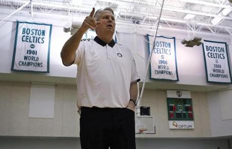 Danny Ainge, Boston Celtics president of basketball operations, gestures as he passes the team's NBA vhampionship banners st the team's training facility in Waltham, Mass., Tuesday, May 16, 2017. The Celtics had won the NBA draft lottery, capitalizing on a trade they made with the Brooklyn Nets four years ago. (AP Photo/Charles Krupa)
