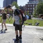 Students who were visiting Boston from Cape Elizabeth Middle School in Maine jumped into the fountain along the Rose Kennedy Greenway as temperatures went into the 90's in Boston.  