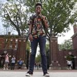 Obasi Shaw posed outside the gates of Harvard Yard in Cambridge.