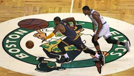 Boston, MA May 19, 2017: The Cavaliers Kyrie Irving stole the ball from the Celtics Marcus Smart and raced to the basket, where he dished the ball off to a teammate for an easy two points. The Boston Celtics hosted the Cleveland Cavaliers in Game Two of their NBA Eastern Conference Finals playoff series at the TD Garden. (Globe Staff Photo/Jim Davis) 
