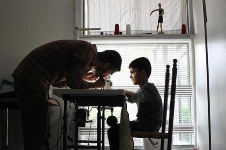 Nine-year-old Mustafa Hayani is the same age his father, Adbulkader ,had been when he left school in Syria for good to start working as a tailor. 

