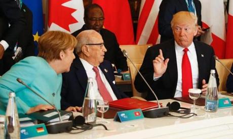 U.S. President Donald Trump talks to German Chancellor Angela Merkel (L) and Tunisia's President Beji Caid Essebsi (2-L) at the G7 Summit expanded session, on May 27, 2017 in Taormina, Sicily. /
