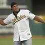 Former Oakland Athletics player Jose Canseco throws out the ceremonial first pitch prior to a baseball game against the Boston Red Sox, Saturday, Sept. 3, 2016, in Oakland, Calif. (AP Photo/Ben Margot)