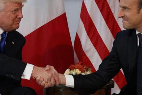 FILE - In this May 25, 2017 file photo, President Donald Trump shakes hands with French President Emmanuel Macron during a meeting at the U.S. Embassy in Brussels. Trump hasn?t done a lot of public speaking during his big trip abroad. But the president?s body language and that of those around him has spoken volumes. (AP Photo/Evan Vucci, File)
