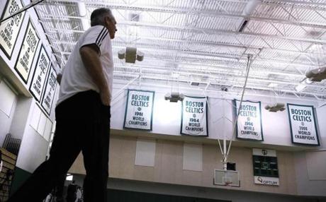 Danny Ainge, Boston Celtics president of basketball operations, walks past the team's NBA championship banners at the team's training facility in Waltham, Mass., Tuesday, May 16, 2017. The Celtics won the NBA draft lottery earlier Tuesday, capitalizing on a trade they made with the Brooklyn Nets four years ago. (AP Photo/Charles Krupa)
