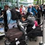 Passengers lined up with their luggage outside Heathrow Airport Terminal 5 on Sunday in London as thousands of travelers faced a second day of disruption after a computer failure caused the airline to cancel most of its services.