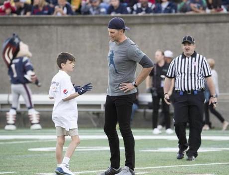 6/2/17 Allston, MA Tom Brady and son Jack Tom Brady quarterbacked for both teams at the 18th annual Best Buddies Challenge held at Harvard Stadium. Also attending were Brady's son Jack, Charlie and Lauren Baker, Danny Amendola and his girlfriend Olivia Culpo, Julian Edelman, James White, Dion Lewis_Dan Koppen, and Scott Zolak Image Jay Connor
