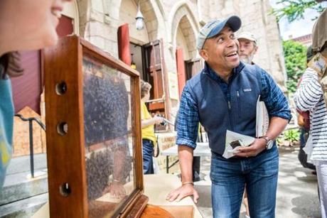 Former governor Deval Patrick examined a hive during the Langstroth Bee Fest held at the Second Congregational Church in Greenfield.
