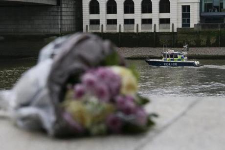 A single bunch of flowers lies on a wall on the northern bank of the River Thames close to London Bridge (L) as a police boat patrols the river in London on June 4, 2017, in tribute to the victims of the June 3 terror attack on the bridge and at Borough Market. Seven people were killed in a terror attack on Saturday by three assailants on London Bridge and in the bustling Borough Market nightlife district, the chief of London's police force said on Sunday. / AFP PHOTO / Daniel LEAL-OLIVASDANIEL LEAL-OLIVAS/AFP/Getty Images
