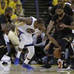 Golden State Warriors forward Kevin Durant (35) reaches for the ball between Cleveland Cavaliers guard Kyrie Irving, left, and center Tristan Thompson (13) during the second half of Game 2 of basketball's NBA Finals in Oakland, Calif., Sunday, June 4, 2017. (AP Photo/Marcio Jose Sanchez)