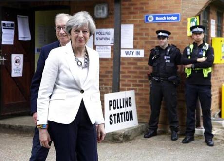 Britain's Prime Minister Theresa May leaves with her husband Philip after voting in the general election at polling station in Maidenhead, England, Thursday, June 8, 2017. (AP Photo/Alastair Grant)
