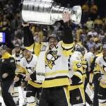 Pittsburgh Penguins' Sidney Crosby (87) celebrates with the Stanley Cup after defeating the Nashville Predators in Game 6 of the NHL hockey Stanley Cup Final, Sunday, June 11, 2017, in Nashville, Tenn. (AP Photo/Mark Humphrey)