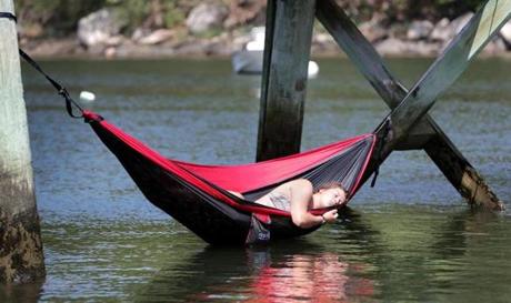 Between dips in the cool water below, Grace Papp relaxed in her hammock on the supports of the footbridge across Lobster Cove in the Annisquam neighborhood of Gloucester on Sunday.
