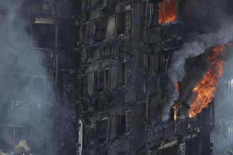 LONDON FIRE SLIDER Smoke and flames billow from a massive fire that raged in a high-rise apartment building in London, Wednesday, June 14, 2017. A deadly night-time fire raced through a 24-story apartment tower in London early Wednesday, killing at least six people and injuring dozens more. (AP Photo/Matt Dunham)
