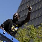 Golden State Warriors' Draymond Green waves at fans during a parade and rally in honor of the Warriors, Thursday, June 15, 2017, in Oakland, Calif., to celebrate the team's NBA basketball championship. (AP Photo/Marcio Jose Sanchez)