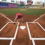 Boston, Ma-June 10, 2016-Stan Grossfeld/Globe Staff- Minutes before gametime, a member of the Fenway grounds crew puts a final touchup of white paint on the batters box.