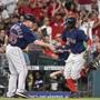 Boston Red Sox' Mookie Betts, right, shakes hands with third base coach Brian Butterfield after hitting the go-ahead solo home run off Houston Astros relief pitcher Will Harris during the eighth inning of a baseball game, Friday, June 16, 2017, in Houston. (AP Photo/Eric Christian Smith)
