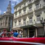 A vintage American car is parked in front of the Inglaterra hotel in Havana, Cuba, Saturday, June 17, 2017. United States President Donald Trump declared he was restoring some travel and economic restrictions on Cuba that were lifted as part of the Obama administration's historic easing.(AP Photo/Ramon Espinosa)