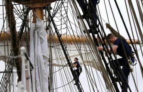 Cadets climb the rigging Saturday while dousing the sails aboard the USCGC Eagle during the Grand Parade of Sail in Boston.
