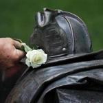 A rose was placed on the memorial wall during today?s ceremony for the Boston firefighters killed at the Hotel Vendome fire.