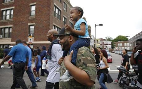 Boston, MA -- 6/18/2017 - Akeem Jackson (C) carries his daughter Aubrey, 3, on his shoulders during the Father's Day Unity Walk. (Jessica Rinaldi/Globe Staff) Topic: 19fathers Reporter: 
