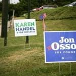 Campaign signs for Karen Handel, the Republican candidate, and Jon Ossoff, the Democrat.