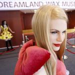 A laborer stapled carpeting next to wax figures of pop singers Katie Perry and Amy Winehouse at the Dreamland Wax Museum in Boston.