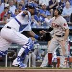 Boston Red Sox's Deven Marrero runs home past Kansas City Royals catcher Salvador Perez to score on a single by Mookie Betts during the third inning of a baseball game Tuesday, June 20, 2017, in Kansas City, Mo. (AP Photo/Charlie Riedel)