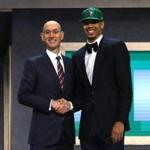 Jayson Tatum walked on stage with NBA commissioner Adam Silver after being drafted third overall by the Boston Celtics on Thursday. 