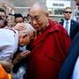 The Dalai Lama greets Jampa Phunkhang of Medford after arriving at the Hyatt Regency Boston in Boston on Saturday.