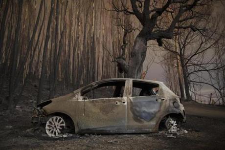 LEIRIA, PORTUGAL - JUNE 18: A burned car stand next to a forest after a wildfire took dozens of lives on June 18, 2017 near Castanheira de Pera, in Leiria district, Portugal. On Saturday night, a forest fire became uncontrollable in the Leiria district, killing at least 62 people and leaving many injured. Some of the victims died inside their cars as they tried to flee the area. (Photo by Pablo Blazquez Dominguez/Getty Images)
