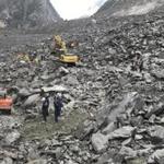 Emergency personnel and earthmoving equipment work at the site of a massive landslide in Xinmo village in Maoxian County in southwestern China's Sichuan Province, Saturday, June 24, 2017. Dozens of people are feared buried by a landslide that unleashed huge rocks and a mass of earth that crashed into their homes in southwestern China early Saturday, a county government said. (Chinatopix via AP)