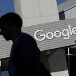 FILE - In this Nov. 12, 2015, file photo, a man walks past a building on the Google campus in Mountain View, Calif. Google said Wednesday, May 11, 2016, that it will ban ads from payday lenders, calling the industry ?deceptive? and ?harmful.? Google said it will no longer allow ads for loans due within 60 days and will also ban ads for loans where the interest rate is 36 percent or higher. The ban is effective July 13. (AP Photo/Jeff Chiu, File)