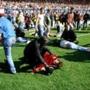 Stewards and supporters tended to wounded supporters on the pitch at Hillsborough Stadium on April 15, 1989. 