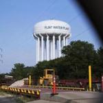 A water tower is seen in Flint, Mich., Wednesday, June 14, 2017. Five people, including the head of Michigan's health department, were charged Wednesday with involuntary manslaughter in an investigation of Flint's lead-contaminated water, all blamed in the death of an 85-year-old man who had Legionnaires' disease. (Shannon Millard/The Flint Journal-MLive.com via AP)