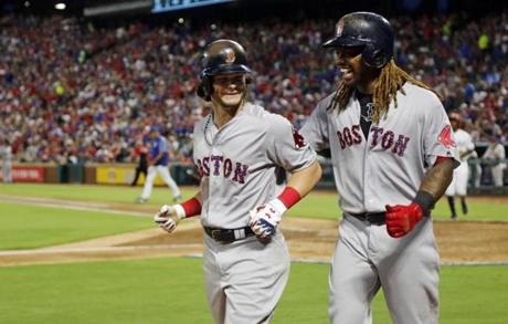 Boston Red Sox left fielder Andrew Benintendi (16) is congratulated by teammate Hanley Ramirez (13) on his three-run home run against the Texas Rangers during the fifth inning of a baseball game Tuesday, July 4, 2017, in Arlington, Texas. (AP Photo/Michael Ainsworth)
