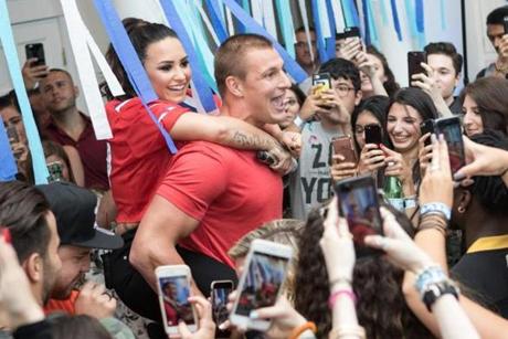 Demi Lovato got a piggy-back ride from Rob Gronkowski at the private performance.
