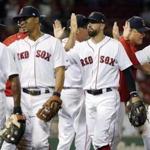Boston Red Sox's Mitch Moreland, center right, celebrates with teammates, from left, Jackie Bradley Jr., Xander Bogaerts and Josh Rutledge, after defeating the Detroit Tigers in a baseball game, Saturday, June 10, 2017, in Boston. (AP Photo/Michael Dwyer)